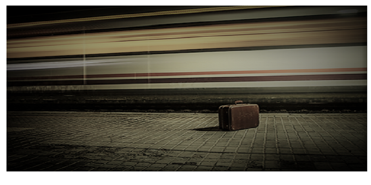 photo of suitcase on subway platform