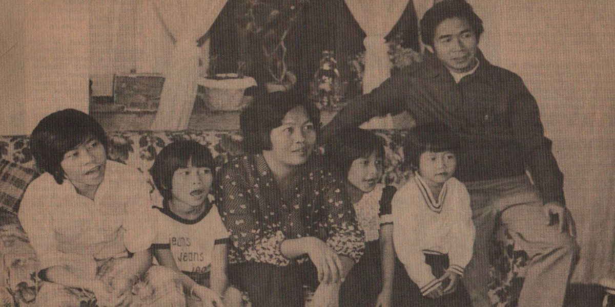 sepia tone image of Chai family on sofa